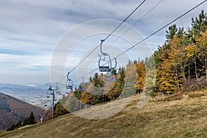 Funicular which been used during the winter season view of seats swinging in strong wind while looking at the landscape and