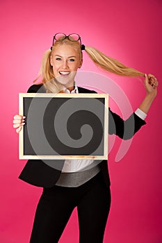 Funky business woman holding a blank blackboard - teacher