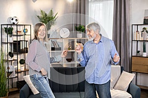 Funky couple dancing together and having fun indoors