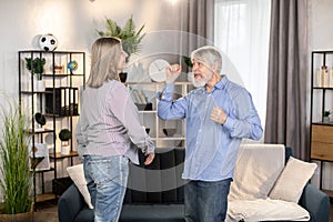 Funky couple dancing together and having fun indoors