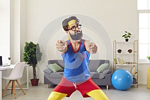 Funny fitness trainer in retro sportswear pointing at camera motivating you to start training
