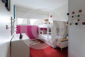 Funky kids bedroom with red carpet and pink painted wall