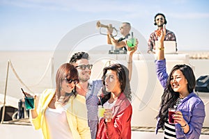 Funky people dancing music and having fun together at beach rave