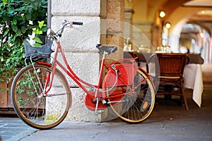 Funky red bike parked on a street in Desenzano del Garda town