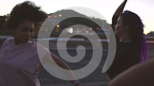 Funky street dancers or city performers dancing hip hop or modern contemporary choreography routine at sunset. Cool