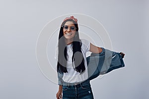 Funky young woman in bandana looking at camera and smiling