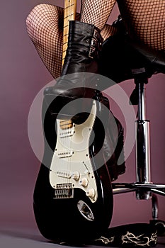 Funky young woman with her black hot guitar