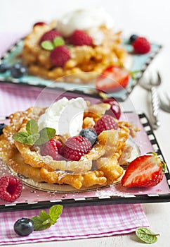 Funnel cakes with fresh berries and whipped cream