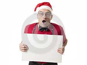 Funny 40s to 50s crazy sales man in Santa Christmas hat with bo