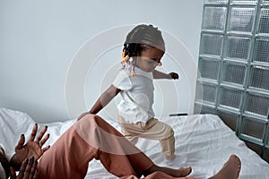 funny adorable kid walking on the bed