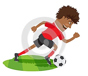 Funny African American soccer football player wearing red t-shirt running kicking a ball and smiling