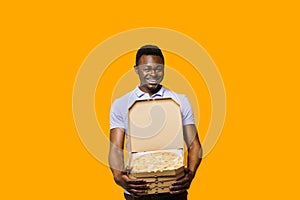 Funny african bearded courier with 4 pizza boxes. Big discount for customers. Tasty food pizza delivery from restaurant