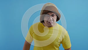 Funny angry Asian man pointing forward giving warn