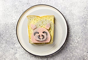 Funny animal sandwich for kids shaped cute pig with boiled sausage and olives