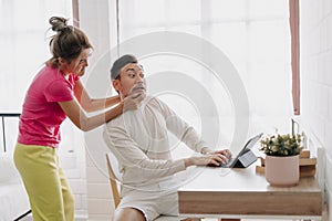 Funny argument couple. Wife force husband to stop his work.