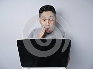 Funny Asian man shocked when Looking at His Laptop