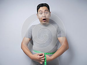 Funny Asian Man SHocked Worried to See His Big Belly, Overweight Problem Concept