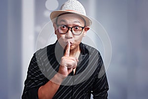 Funny Asian Man Shushing Gesture photo