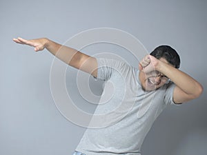 Funny Asian Man Smiling and Making Dab Movement