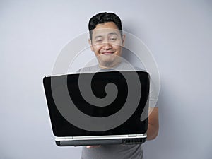 Funny Asian Man Working on His Laptop, Smiling Expression