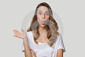 Funny attractive woman showing tongue studio head shot portrait