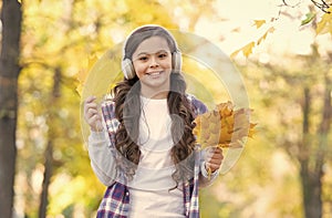 so funny. autumn kid fashion. inspiration. happy childhood. back to school. girl with maple leaves relax in park. fall