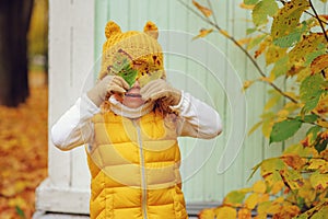 Funny autumn portrait of happy toddler girl walking outdoor