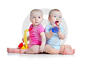 Babies girl and boy play musical toys