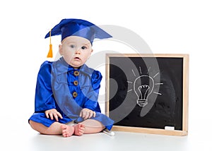 Funny baby in academician clothes at chalkboard