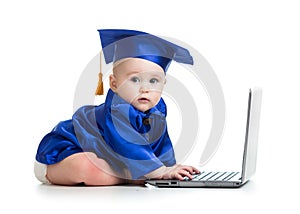 Funny baby in academician clothes using laptop