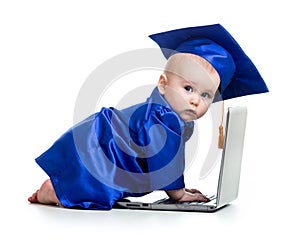 Funny baby in academician clothes using laptop