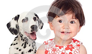 Funny baby with a beautiful dalmatian dog isolated on a white ba