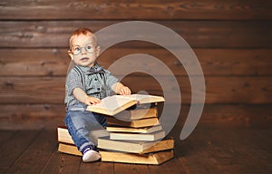 Funny baby with books in glasses