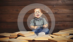 Funny baby with books in glasses