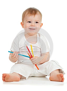 Funny baby boy drawing with color pencils