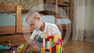 Funny baby boy with educational toy blocks.