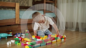 Funny baby boy with educational toy blocks.