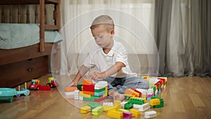 Funny baby boy with educational toy blocks.