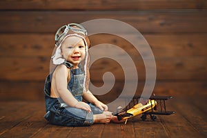 Funny baby boy pilot aviator with airplane laughing