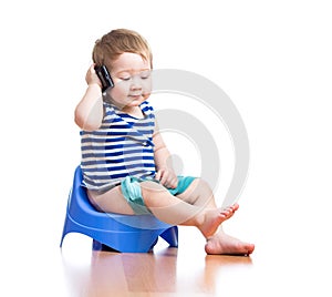 Funny baby boy sitting on chamber pot with pda