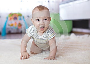 Funny baby crawling on floor at home