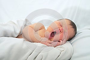 Funny baby face,newborn with jaundice on white blanket, infant healthcare