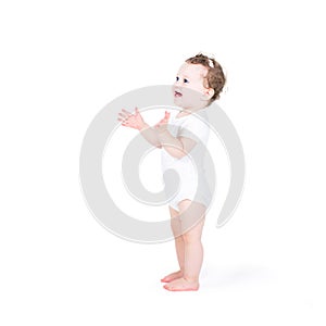 Funny baby girl clapping hands photo