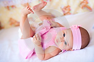 Funny baby girl in a pink dress