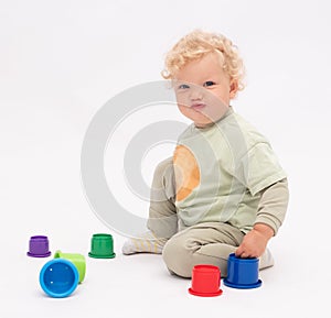 Funny baby girl plays with colorful toys