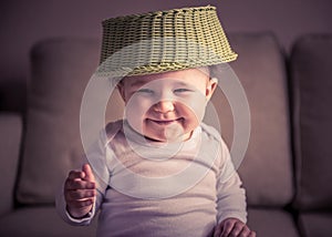 Funny baby plays with fruit dish at home