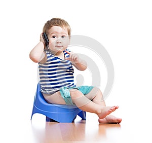 Funny baby sitting on chamber pot with pda