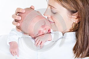 Funny baby sleeping on his mother's shoulder