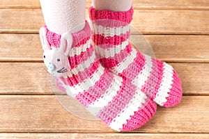 Funny baby socks on the background of wooden table