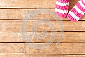 Funny baby socks on the background of wooden table